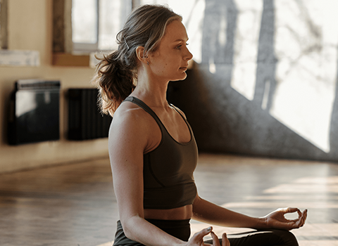 woman in yoga attire meditating