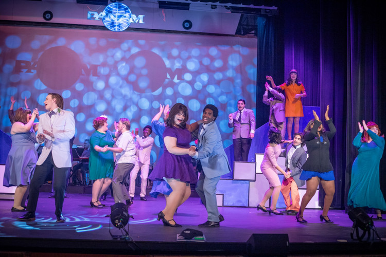 Students dressed up in 50's style clothing dancing and singing during Catch me if you can