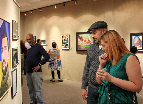 People looking at the art work in the gallery