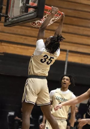 Basketball player dunking the ball