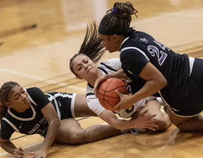 Basketball players struggling for control of the ball