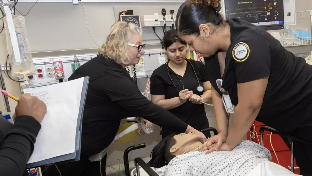 Nursing students operating on medical robot
