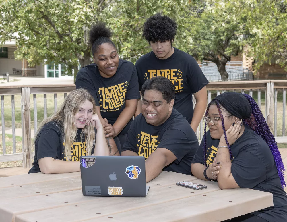 Students Gathered around a laptop