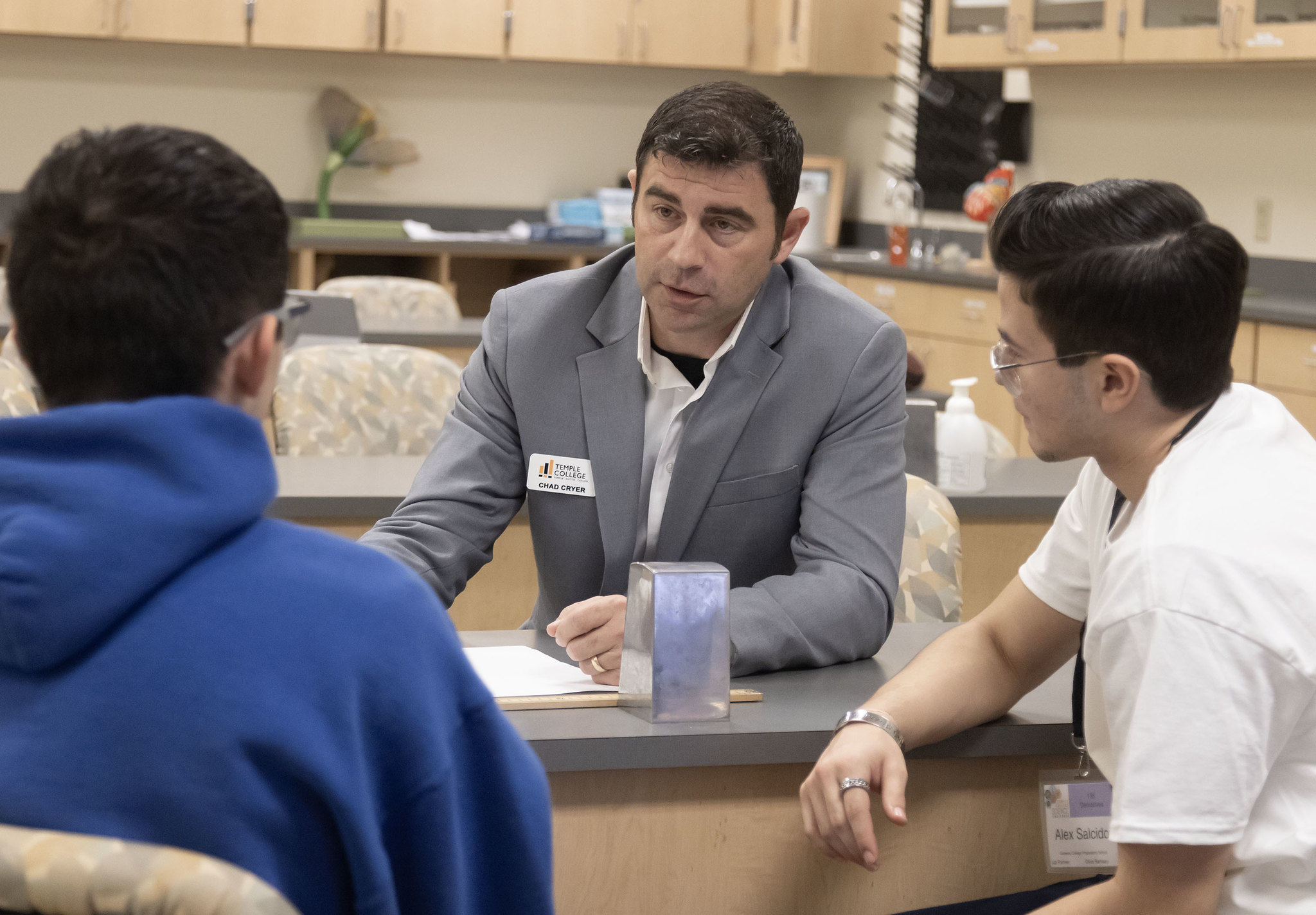 Chad Cryer works with students during Science Challenge