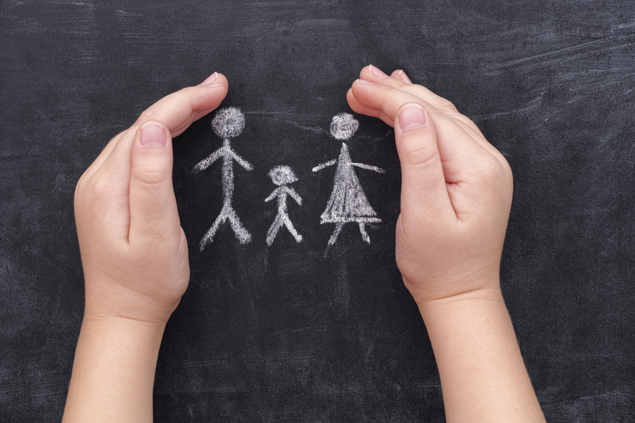 stock images of child's hands on chalkboard with family drawing