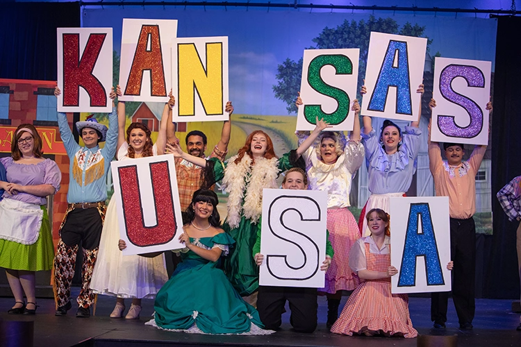 Musical Theater Musical. Performers on stage holding the letters in Kansas USA